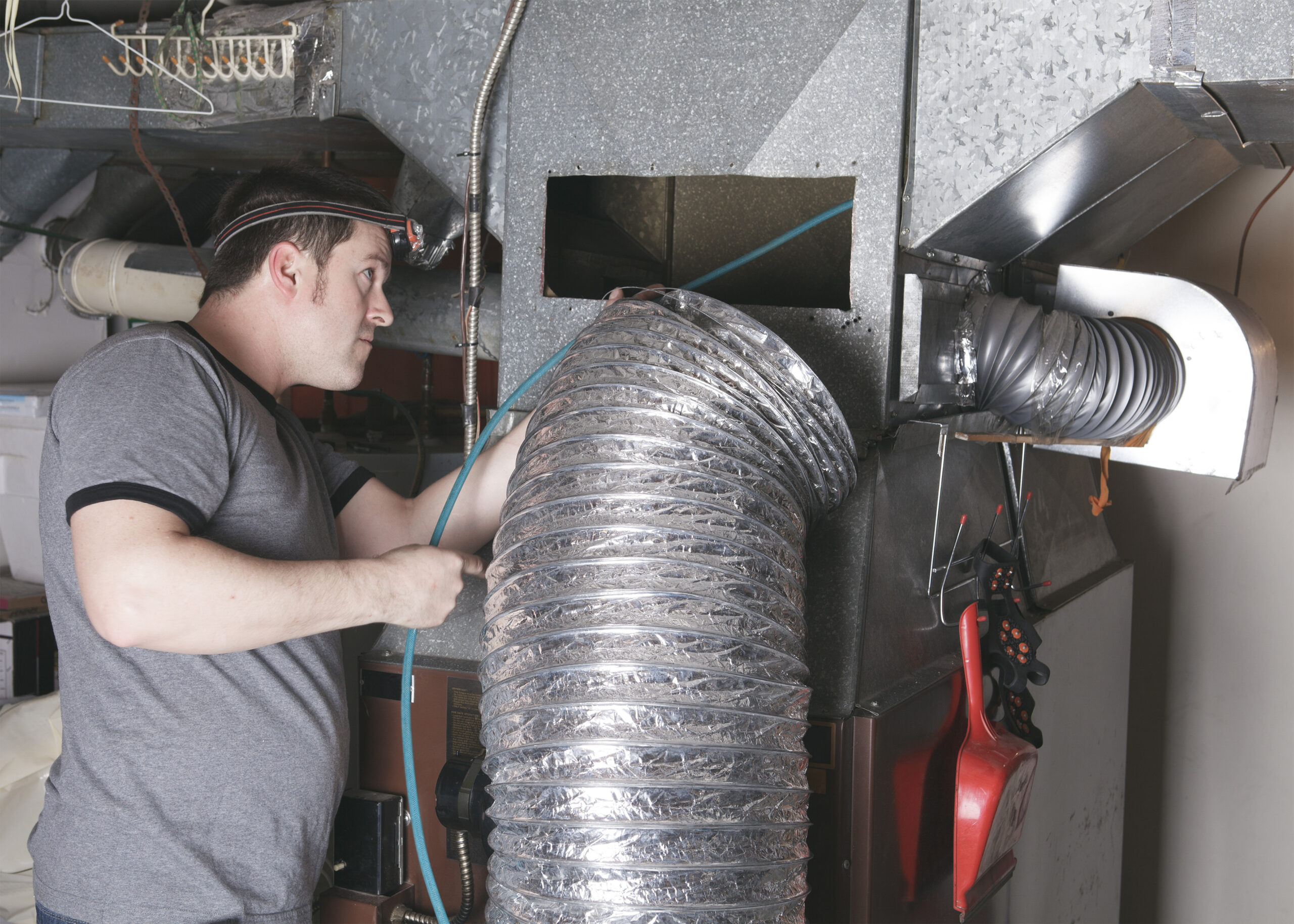 Air duct cleaning technician working in Houston TX